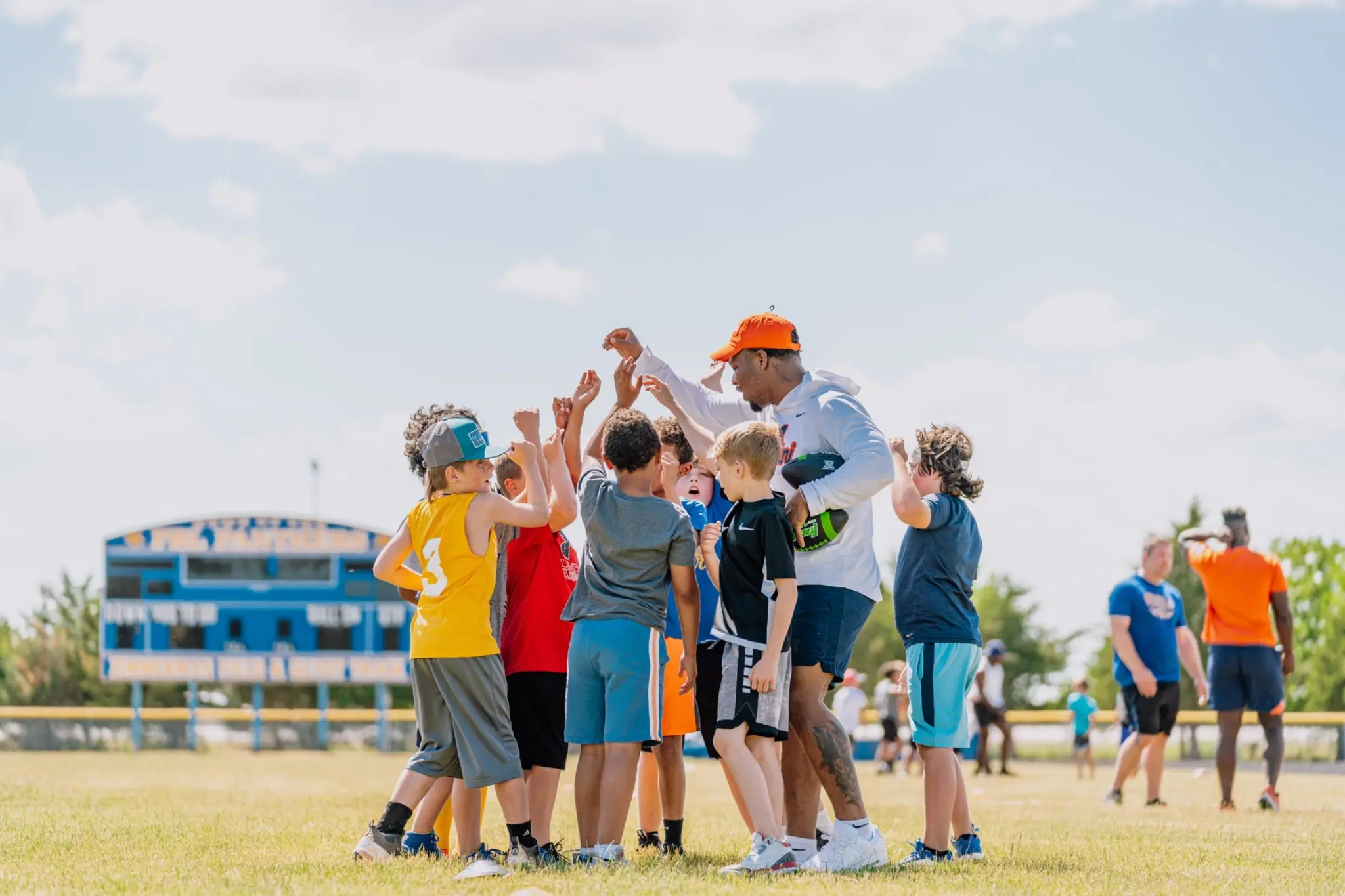 College athletes coaching youth at camp